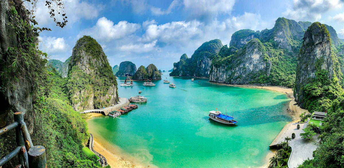Boats on the turquoise water of Ha Long Bay among limestone islands