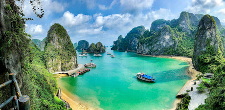 Boats on the turquoise water of Ha Long Bay among limestone islands