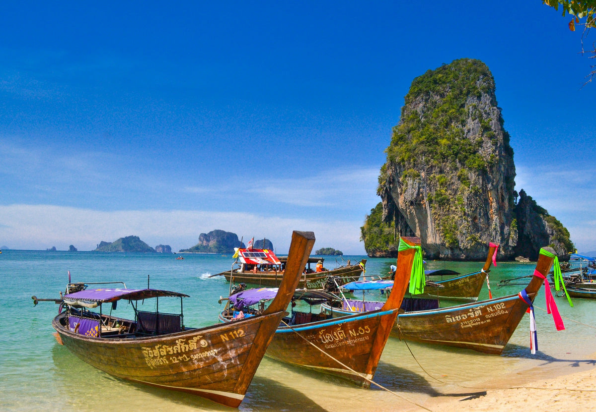 Traditional longtail boats on a beach in Krabi, Thailand